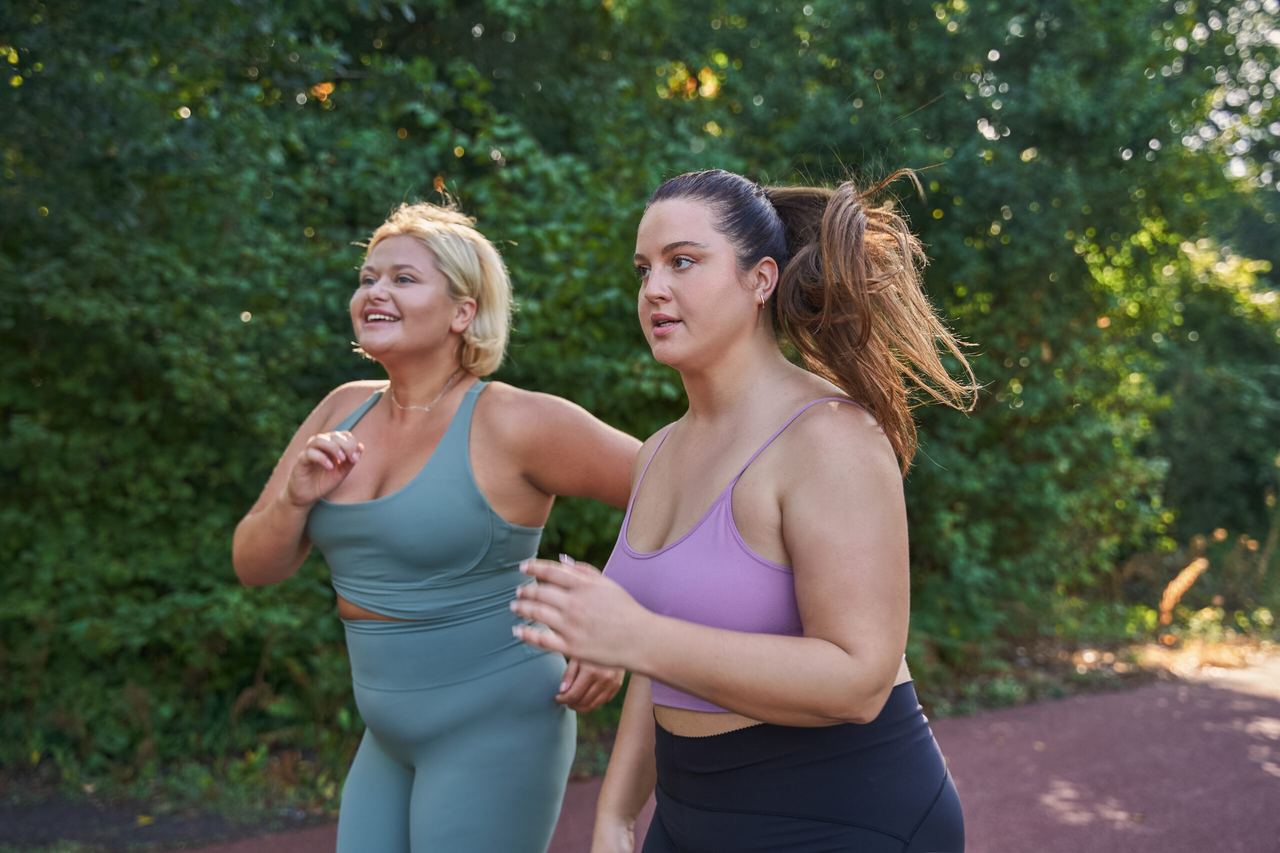 Two women running in nature, using exercise to increase their immune response.