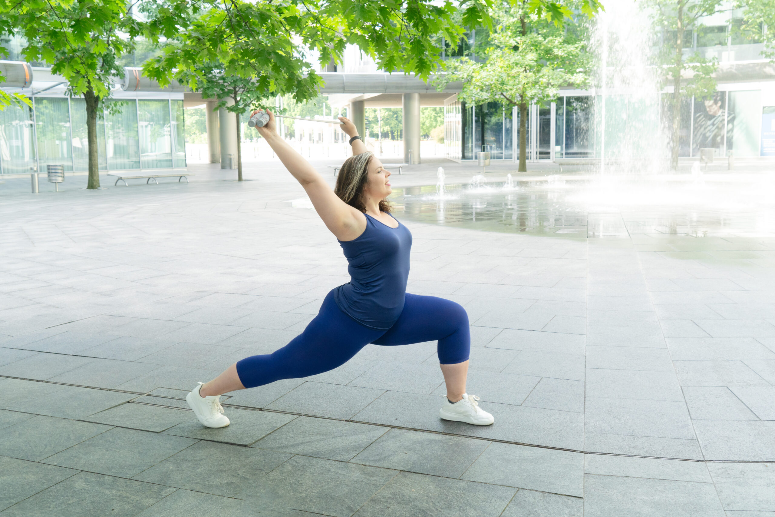 A women in lunge position at the park, exercising to support her immune system and help with Mast Cell Activation (MCAS).