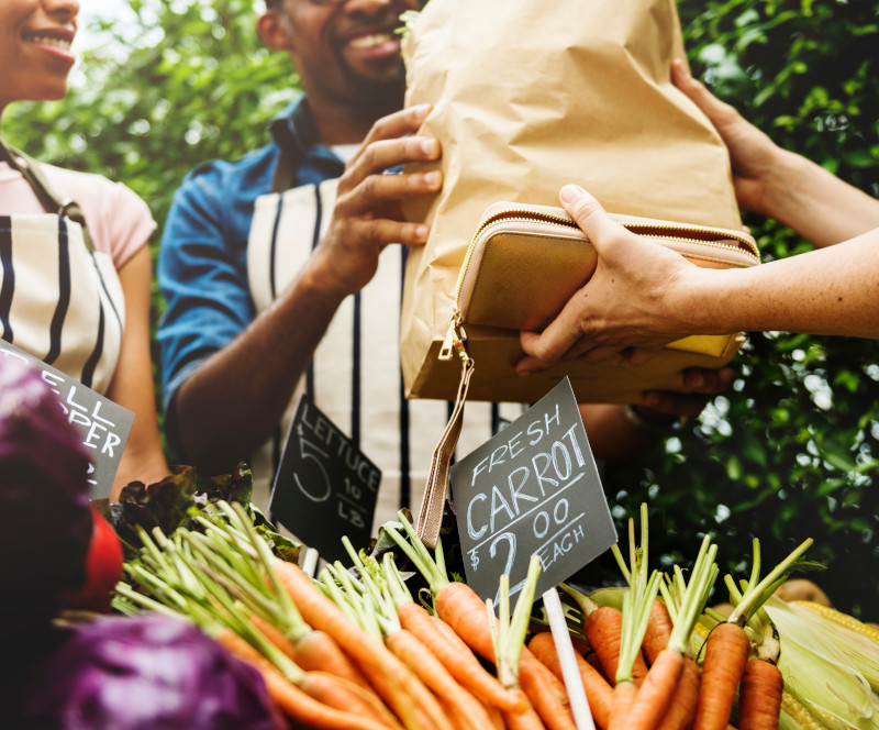 People Buying Vegetable From Shop at Market